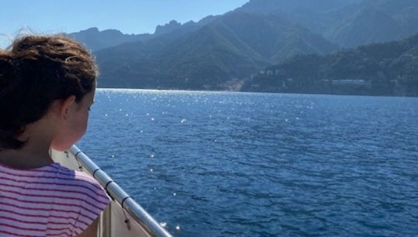 Kid in Amalfi Coast watching the sea