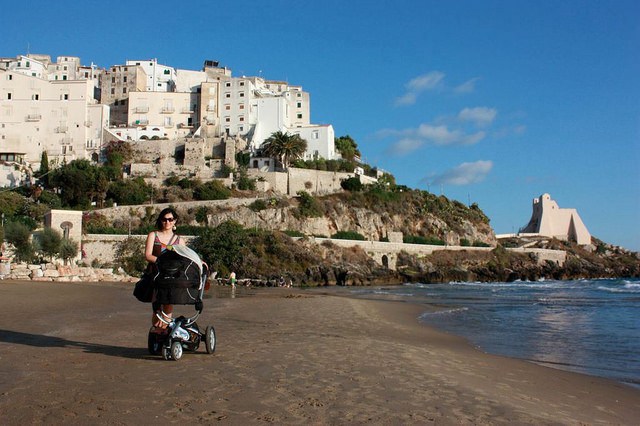 Italy with baby or toddler feature image: mom with pram on italian beach
