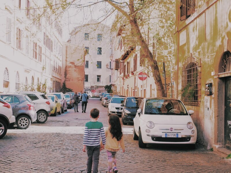 children walking in Rome cobbled street