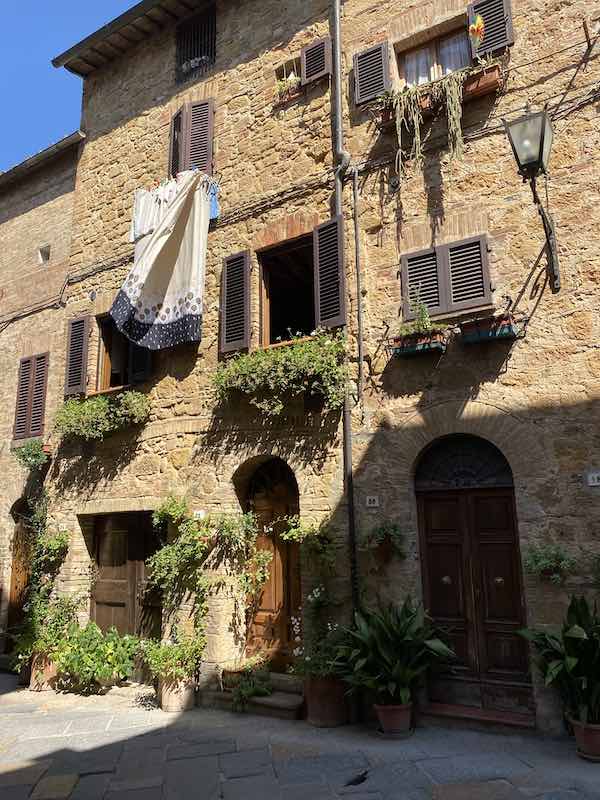 Detail of street in Pienza, Val d Orcia, with laundry drying outside windows