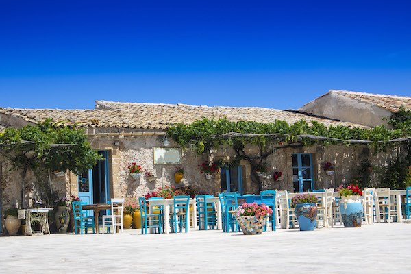 Marzamemi Sicily, square with colorful tables outdoors