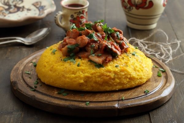 Polenta with meat and sauce on top