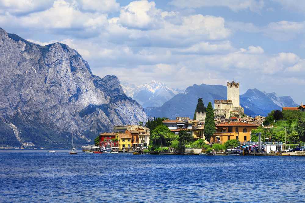 view of town on lake garda with mountain as backdrop