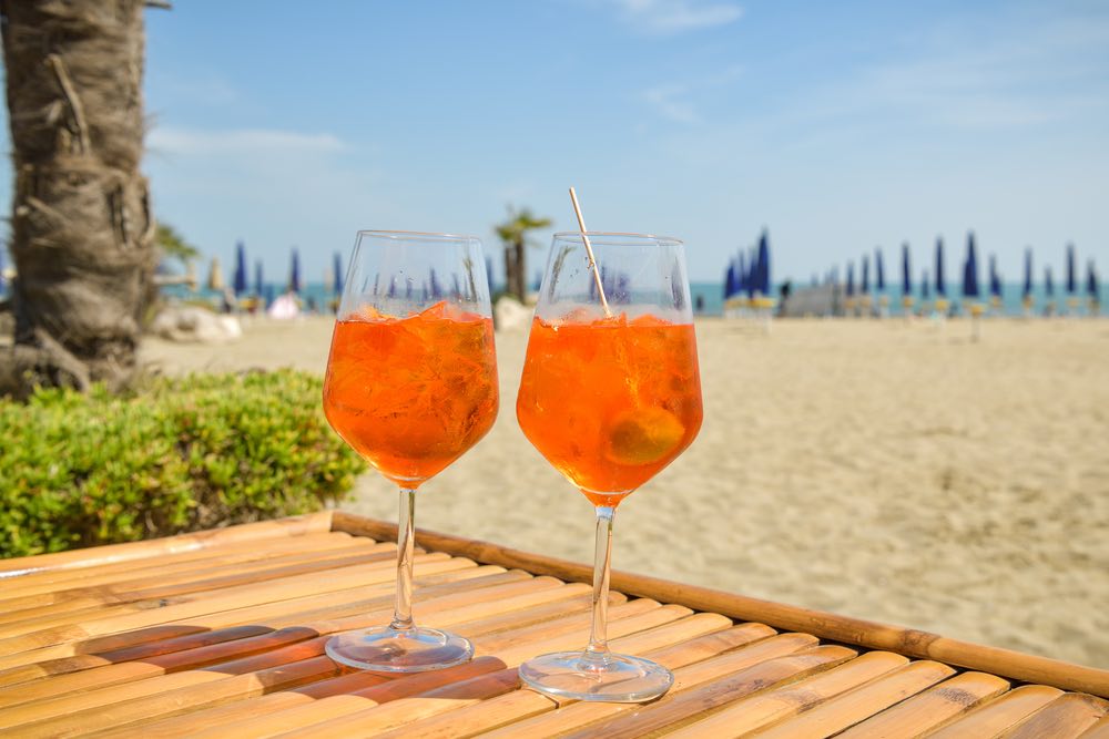 spritz glasses on beach in Venice Italy