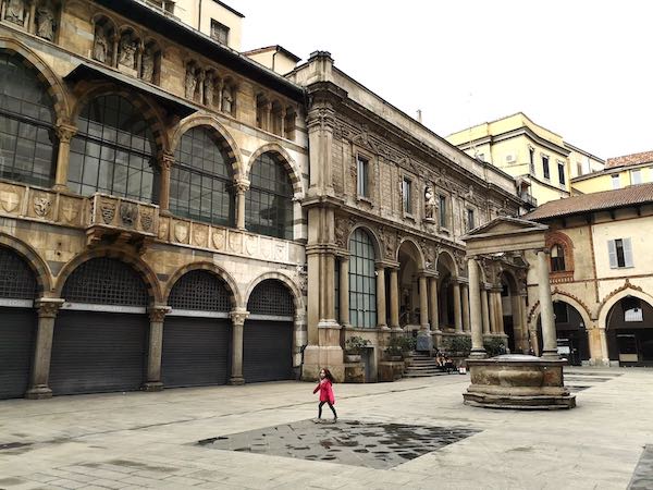Girl running in Piazza dei Mercanti, Milan