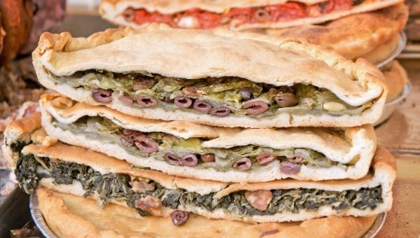 Tiella stuffed with green vegetables and black  Gaeta olives