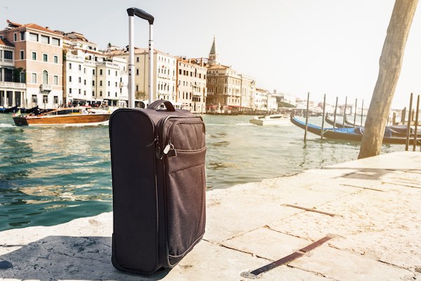 Luggage beside canal in Venice Italy