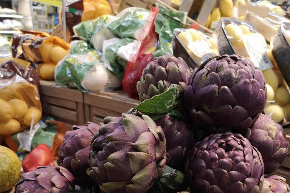 artichokes and other vegetables on Italian market stall