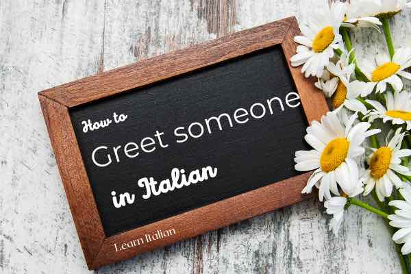 blackboard with writing; how to greet someone in Italian