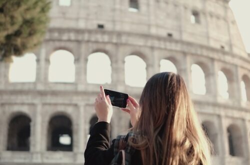 Teemager photographing the Colosseum in Rome