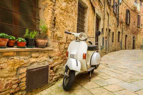 white vespa scooter on Italian medieval street