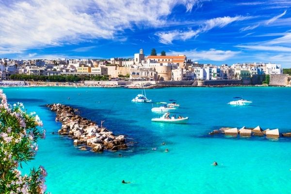 view of Otranto with blue sea and boats in the foreground