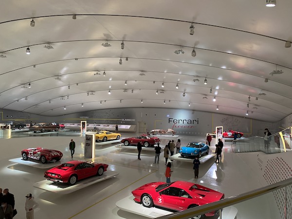 The main hall inside the Enzo Ferrari Museum in Modena with classic cars on display 