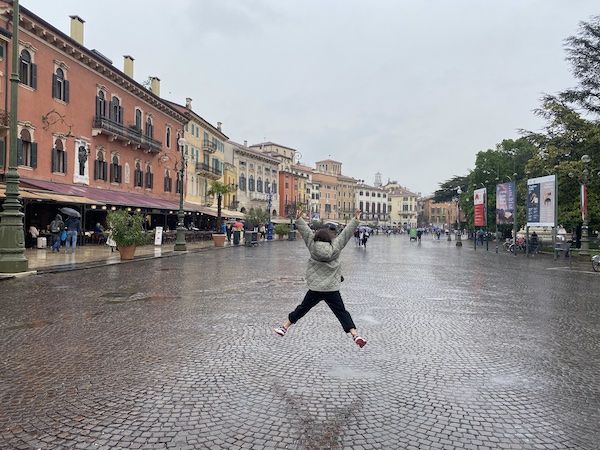 Child jumping in Piazza Bra, Verona