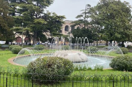 Ancient arena of Verona with park and fountain in front