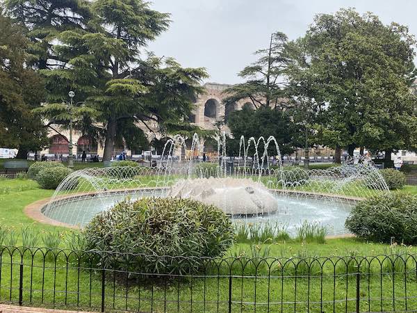 Ancient arena of Verona with park and fountain in front