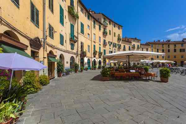 square in Lucca with umbrellas and tables