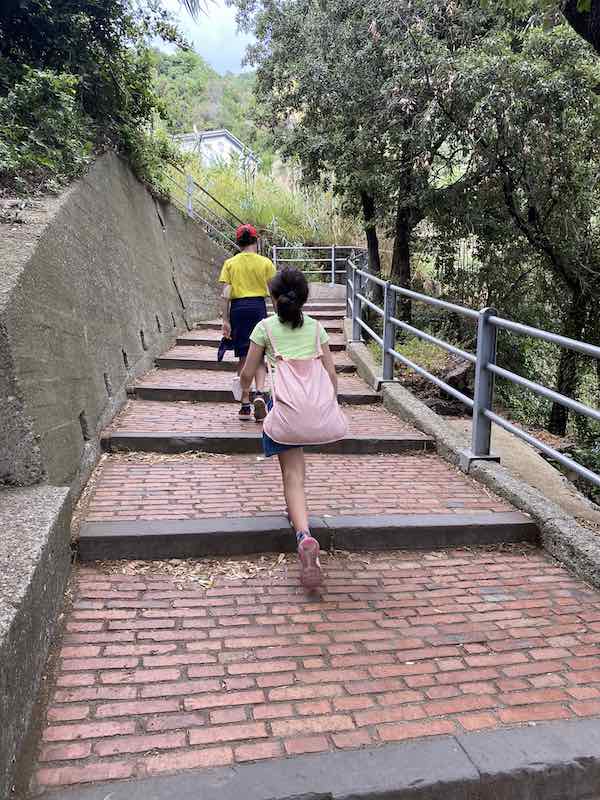My kids climbing up the steps accessing Corniglia
