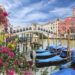 Rialto bridge in Venice with pink flowers in the foreground