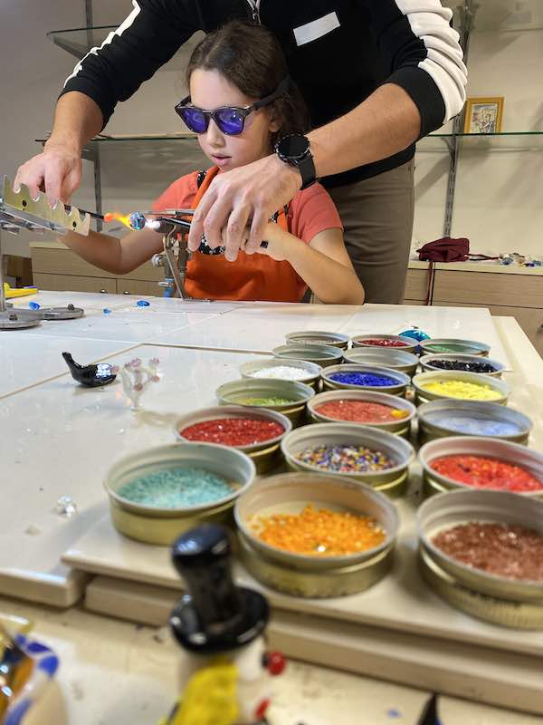 child during a Murano glass makng wokrshop in Venice city center