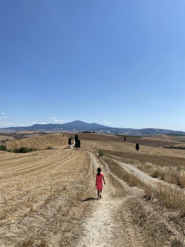 Child walking towards the Gladiators' cypresses in Pienza