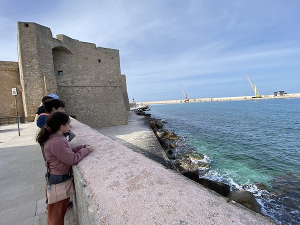 my kids in Monopoli, Puglia, with Monopoli castle in the background