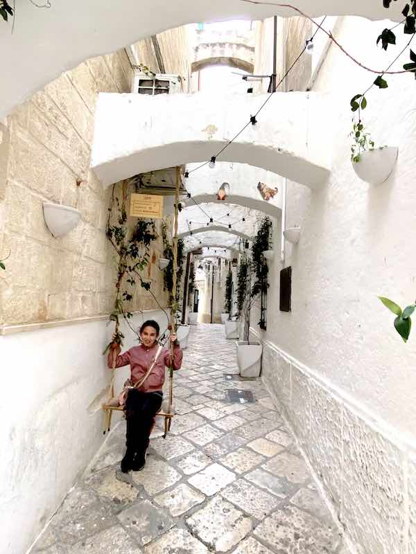 My daughter on a swing in Monopoli town center