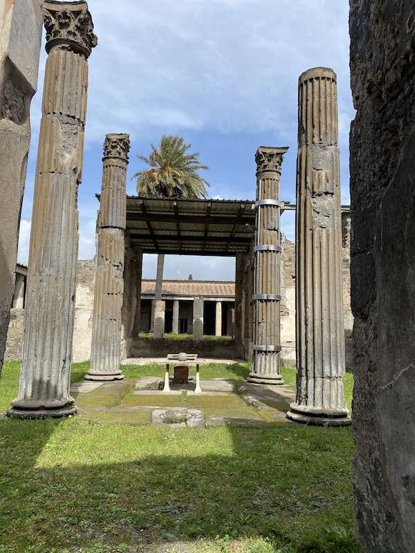 Columns in Pompeii over grass lawn