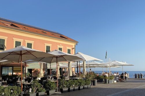 Piazza in Chiavari with cafe with white umbrellas and sea view