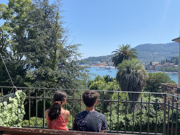 My kids in Santa Marghereita Ligure, sitting on a bench admiring the view