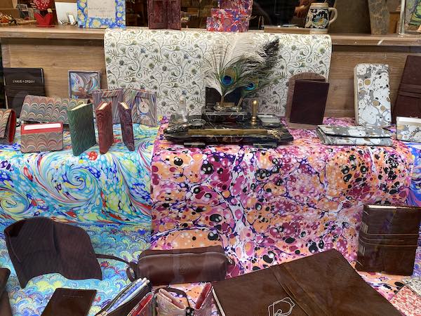 Shop window in Florence with colorful marbled paper and paper bound books