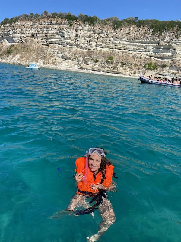 My daugher swimming in Tropea with an orange life jacket