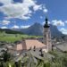 View of Castelrotto with bell tower on the right and the Sciliar Mountain in the background