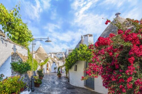 Alberobello, Puglia, trulli houses with pink flowers