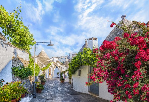 Alberobello, Puglia, trulli houses with pink flowers