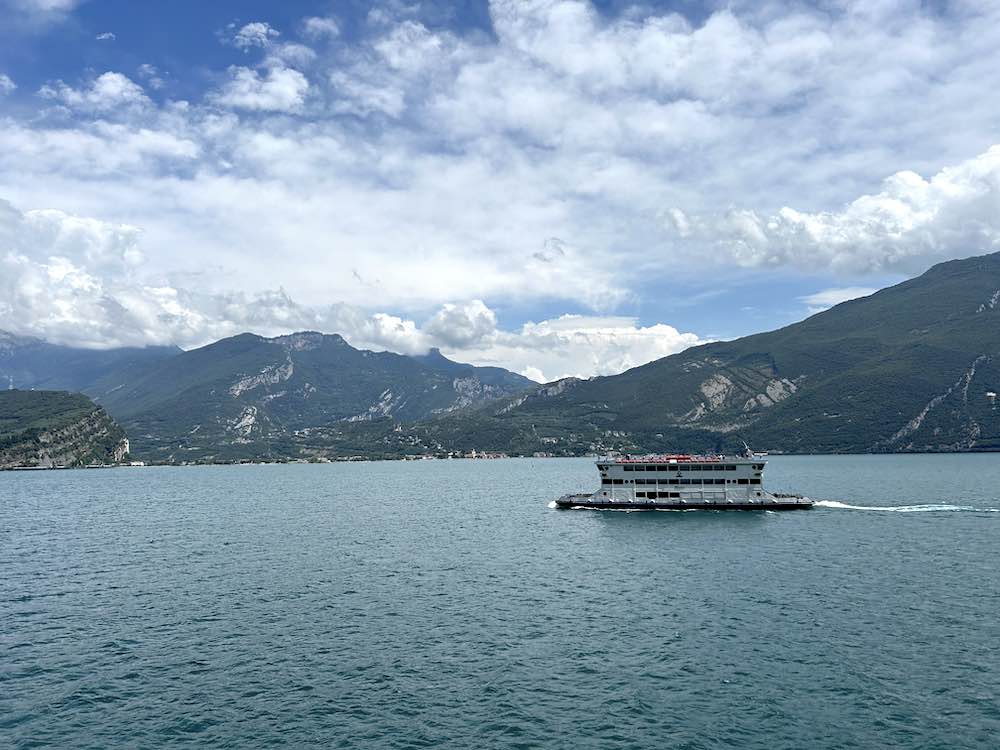 Ferry on Lake Garda with mountains in the distance